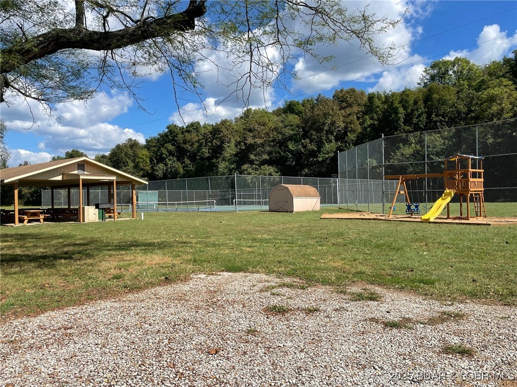 Community grounds with tennis courts, a covered pavilion, and a playground.