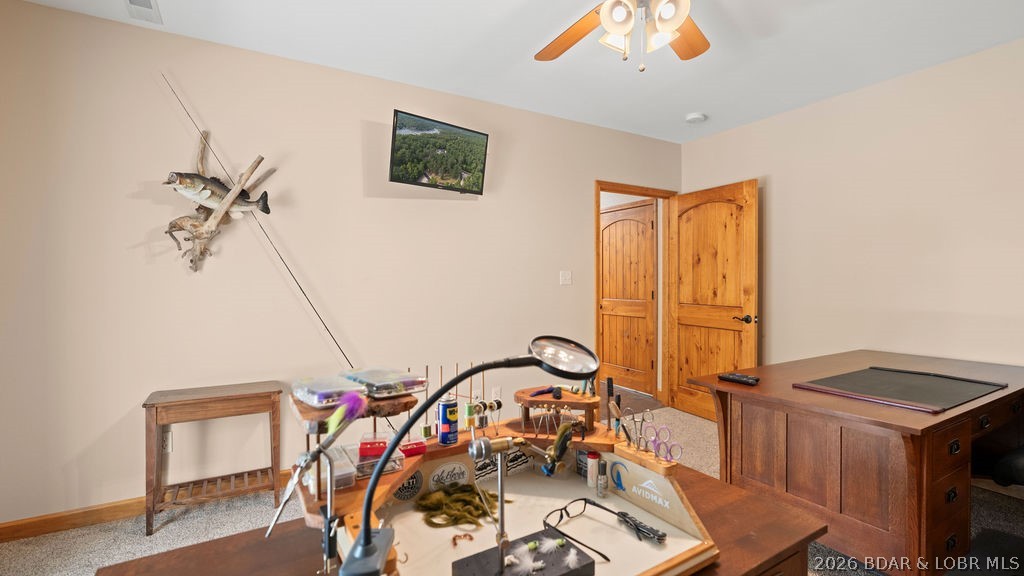Hobby room with a fly-tying workbench, fishing lures, and wooden pool table.