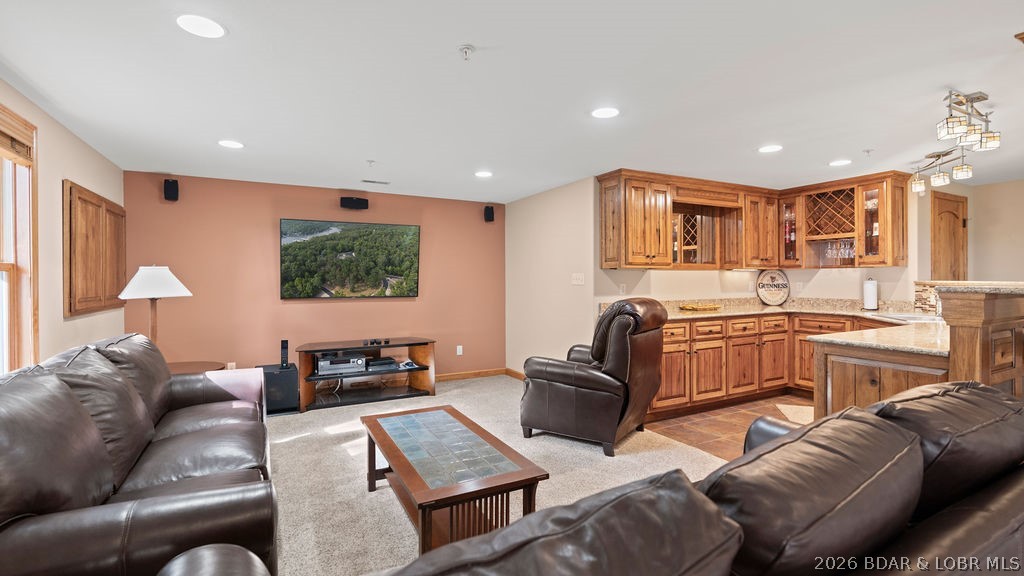 Furnished living room with leather seating and a built-in wood bar.