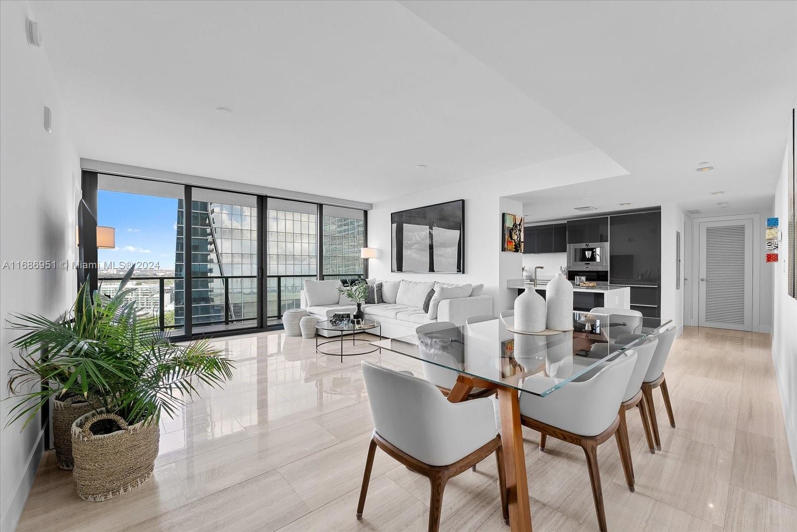 High-rise condo living and dining room with floor-to-ceiling windows, modern furnishings, and city views.