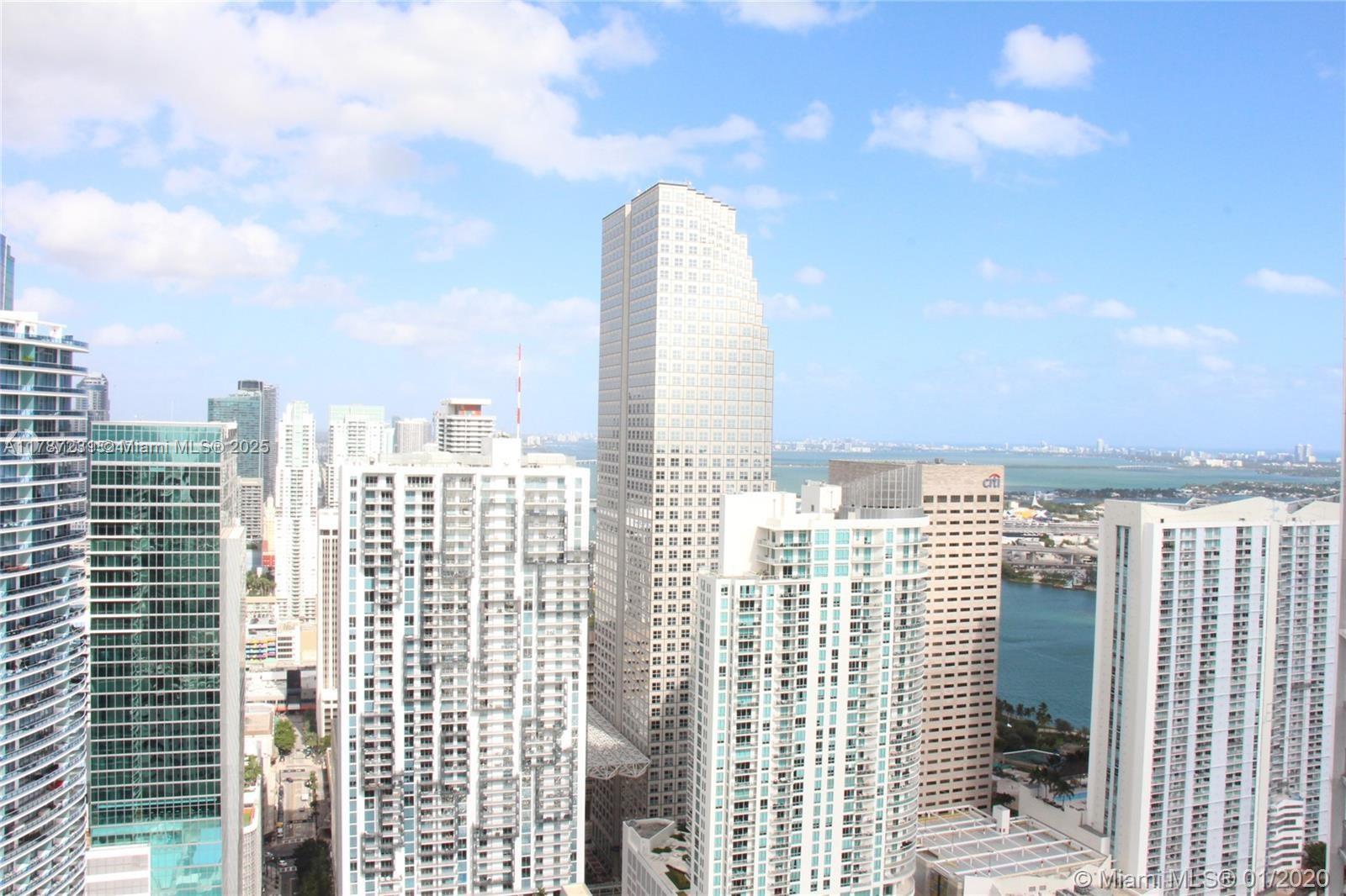 Miami skyline of high-rise buildings with Biscayne Bay in the distance.