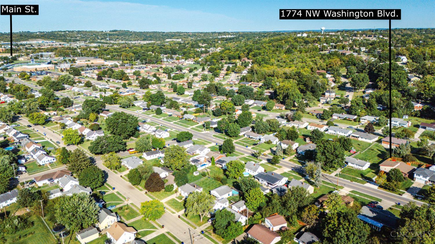 Aerial view of 1774 NW Washington Boulevard in a tree-lined neighborhood near Main Street.