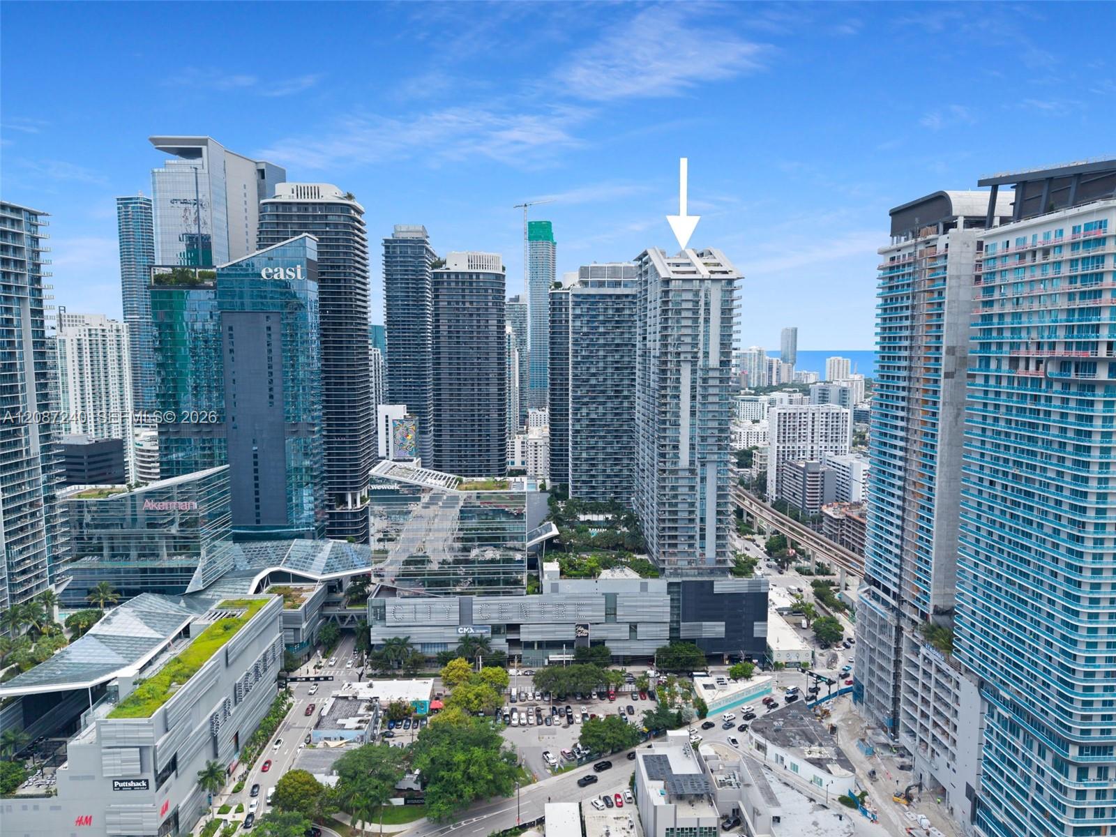 Miami skyline with an arrow marking a high-rise among Brickell City Centre towers.