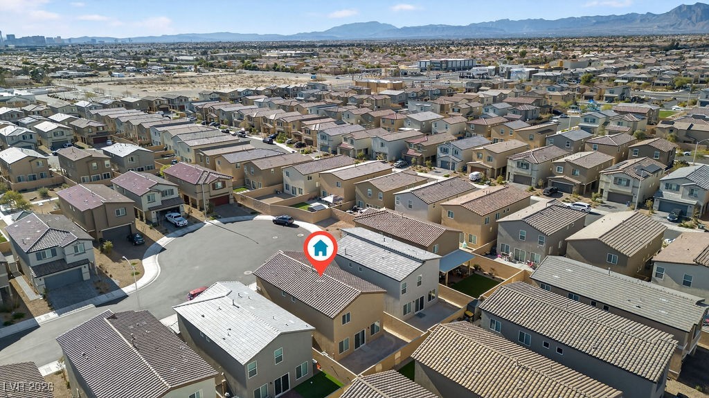 Aerial view of homes in a North Las Vegas neighborhood, with mountains in the distance.