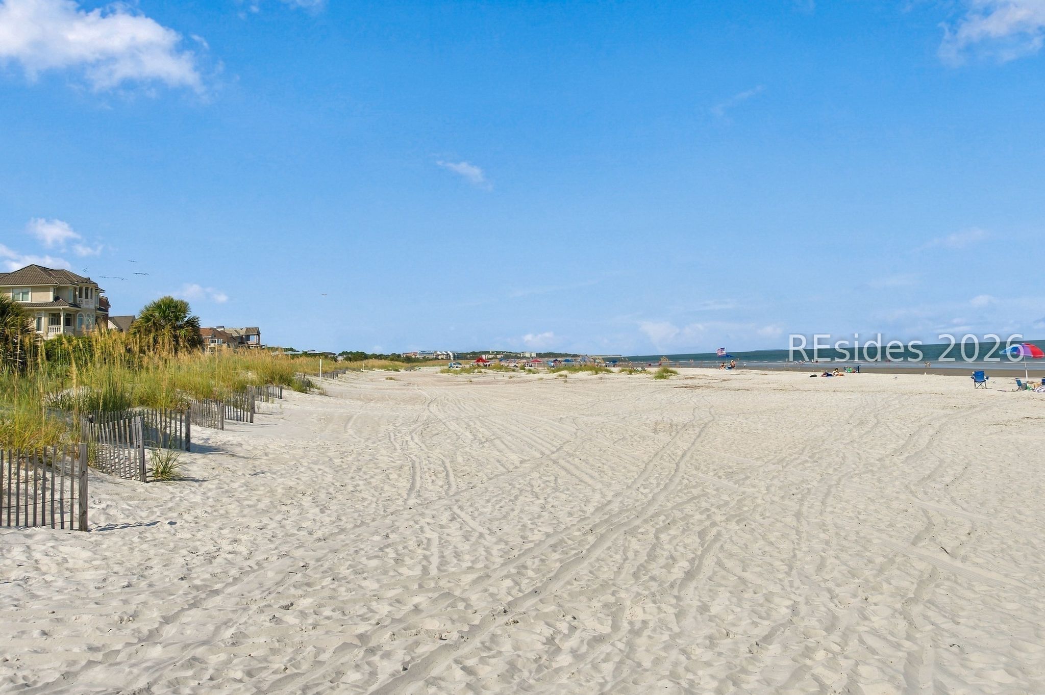 Hilton Head Island beach with dune grass, beachfront houses, and ocean views.