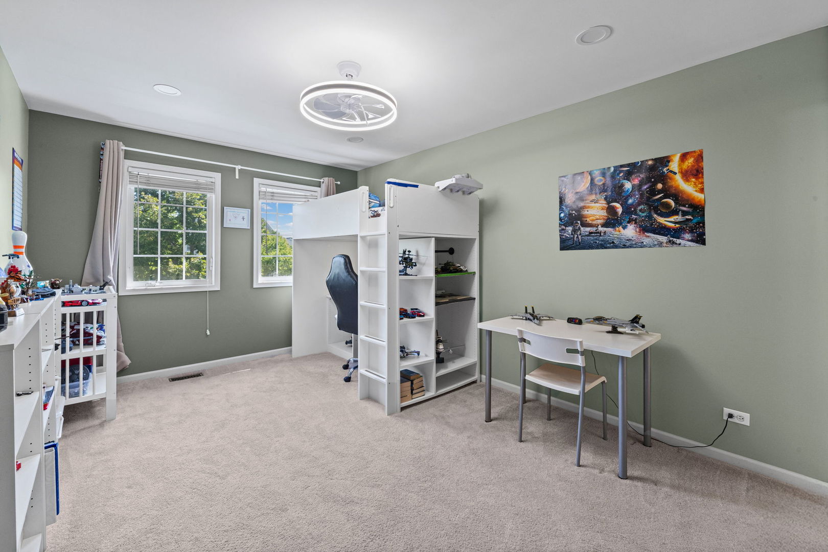 Bedroom with a white loft bunk bed, model aircraft, and space-themed wall art.