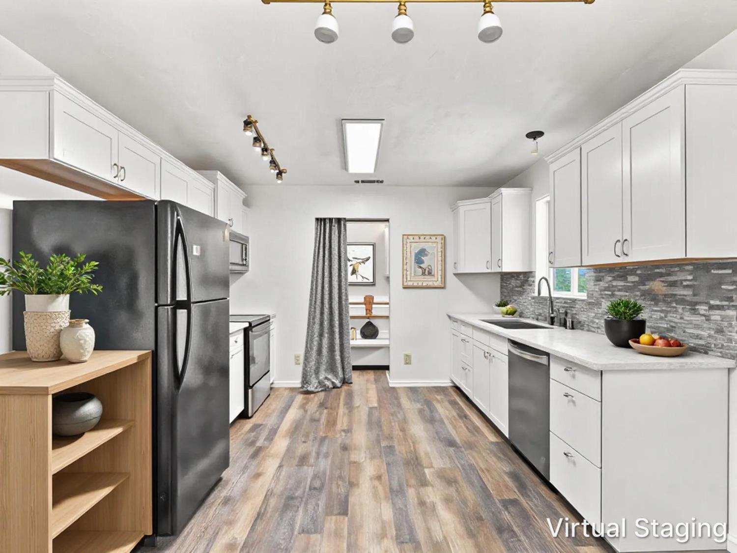 Virtually staged kitchen with white cabinets, gray stone backsplash, and black refrigerator.