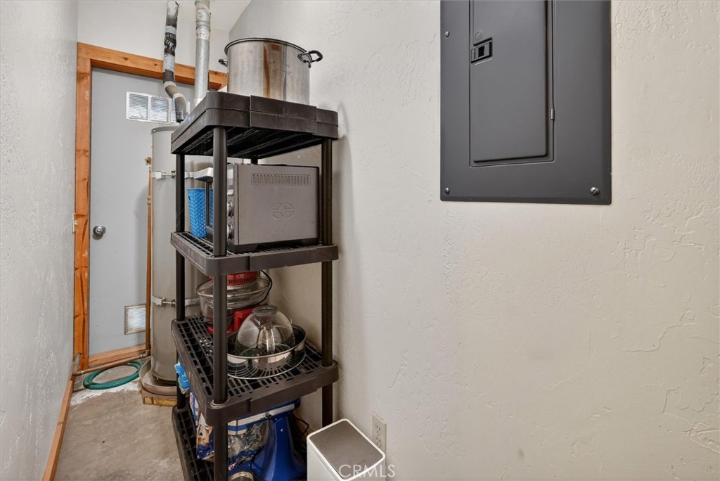 Utility room with an electrical panel and a tall rack of household equipment.