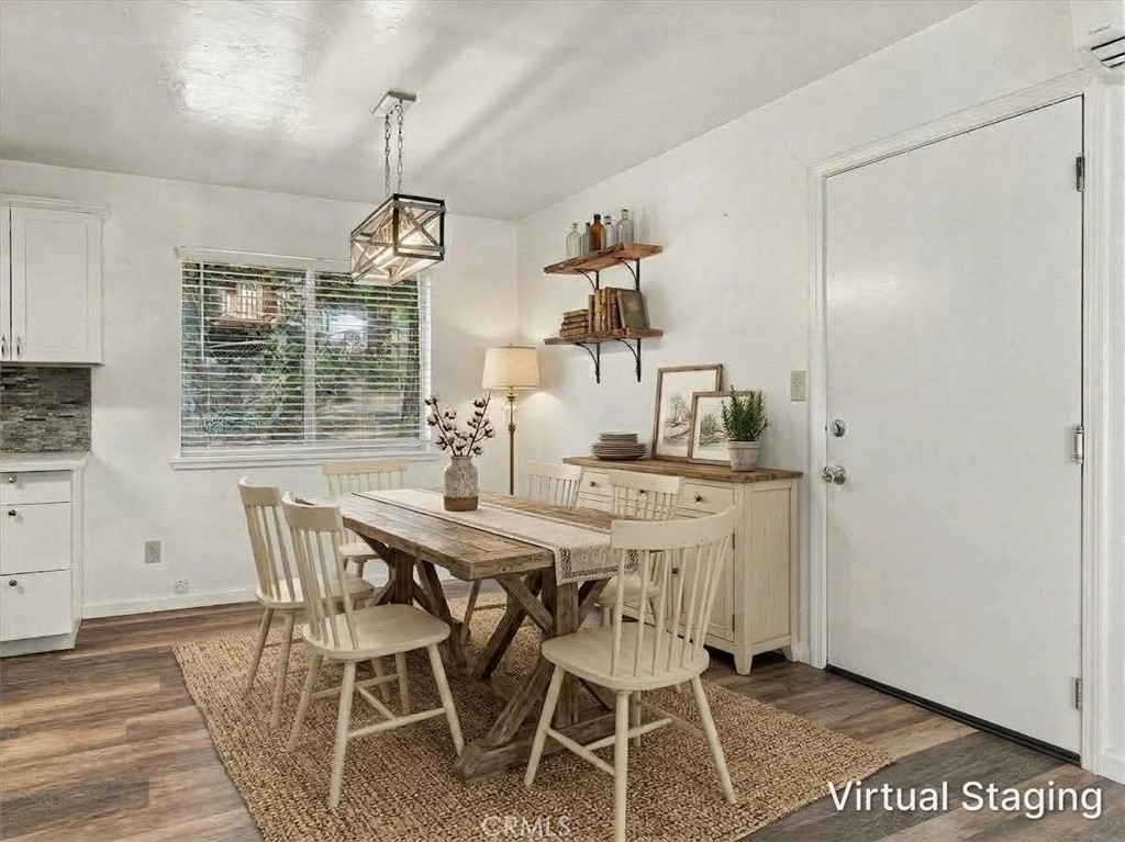 Virtually staged dining room with a rustic wood table, white chairs, and a woven rug.