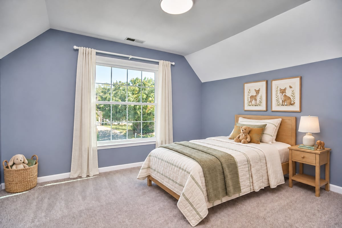 Bedroom with a white bed, blue walls, and a large window overlooking trees.