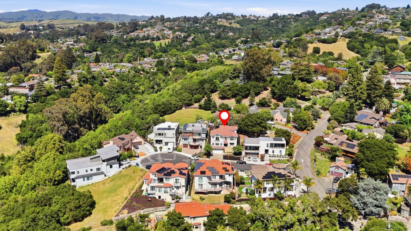 Aerial view of 2390 Rainbow Court marked among homes on a wooded hillside.