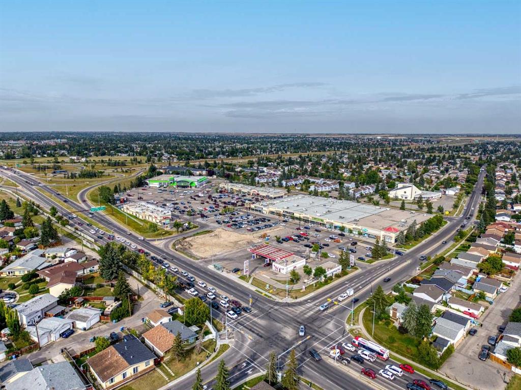 Aerial view of a Calgary neighborhood with a shopping plaza and major intersection.