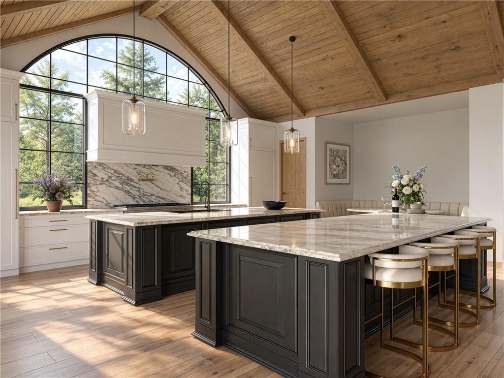 Kitchen with dark marble-topped islands, vaulted wood ceiling, and a large arched window.