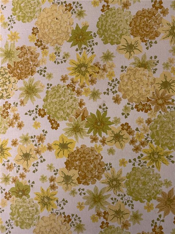 Floral wallpaper with mustard and olive flowers on a pale pink background.