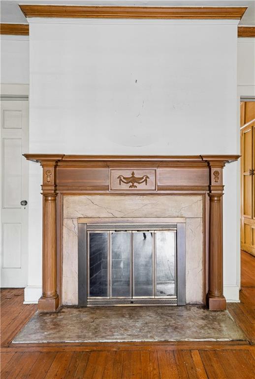 Fireplace with an ornate wood mantel, marble surround, and glass-front insert.