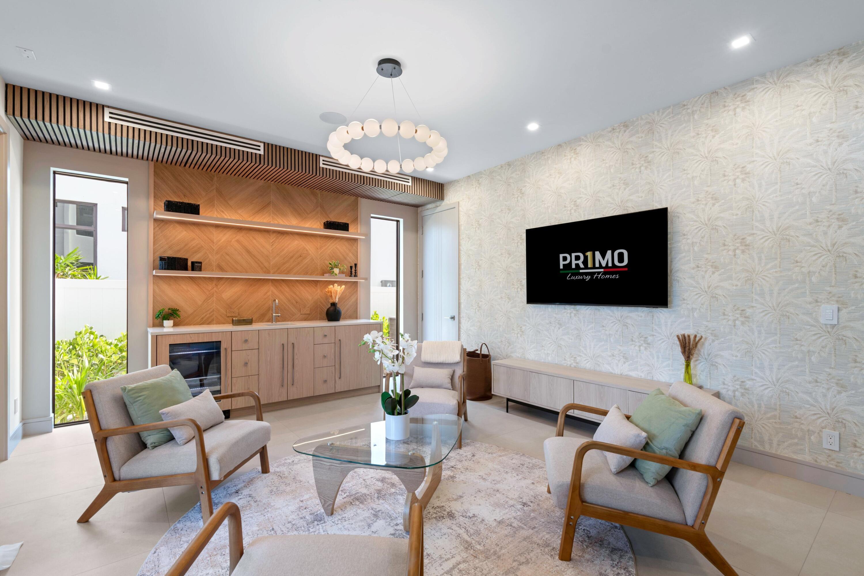 Staged living room with wood cabinetry, glass coffee table, and palm-patterned wallpaper.