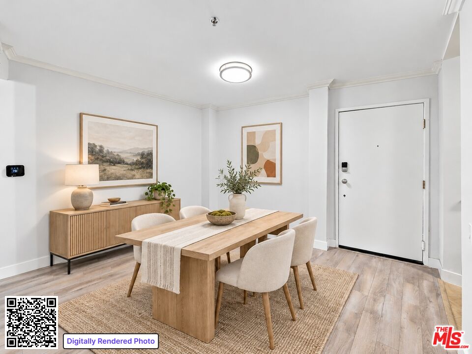 Dining area with a wood table, upholstered chairs, sideboard, and apartment entry door.