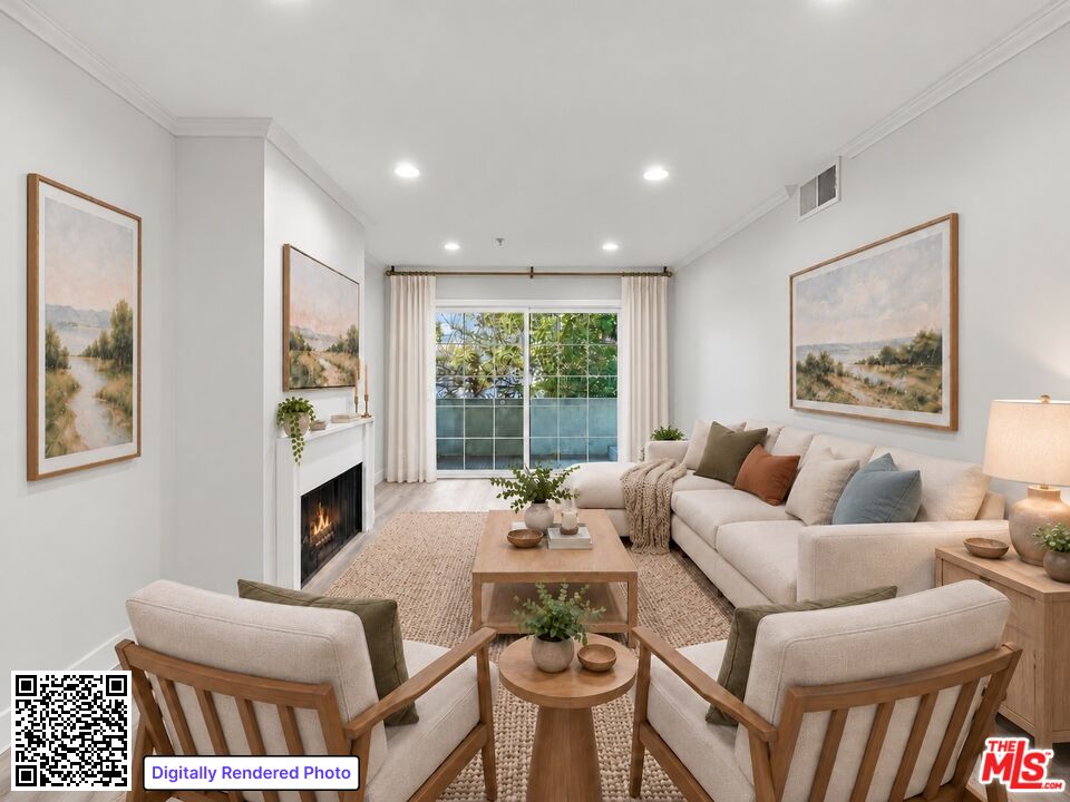 Living room with a fireplace, cream sectional, paired armchairs, and sliding doors to a balcony.
