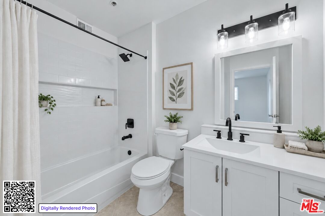 Bathroom with white tub and shower alcove, toilet, and vanity with black fixtures.