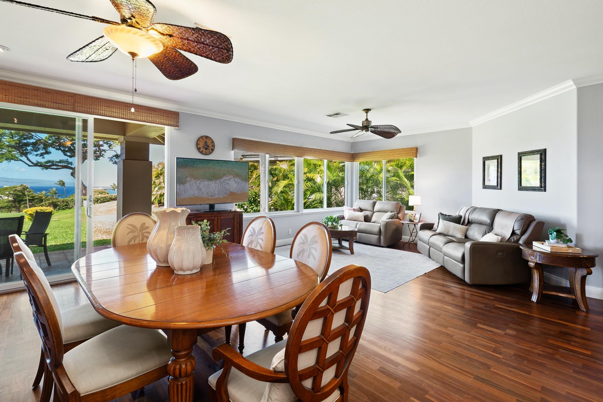 Furnished living and dining room with sliding glass doors overlooking the ocean.