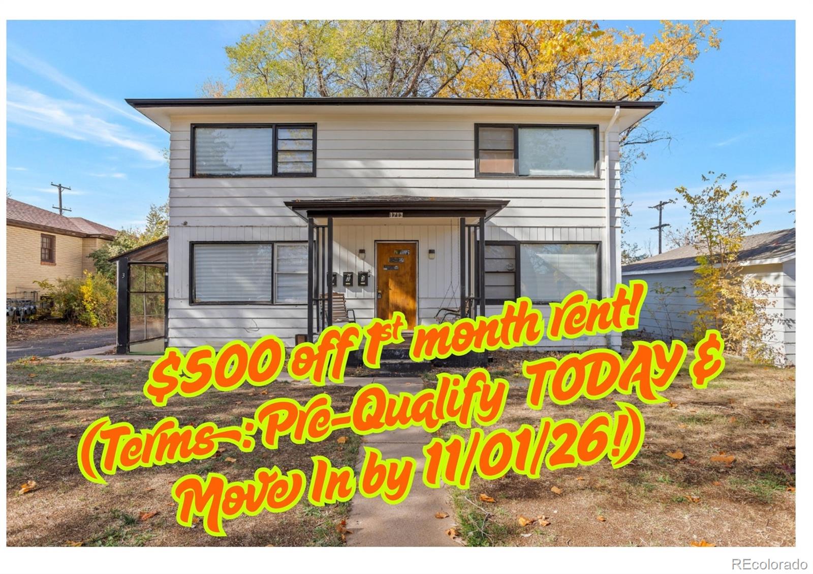 Two-story rental home with white siding, a covered entry, and an autumn yard; banner advertises $500 off first month’s rent.