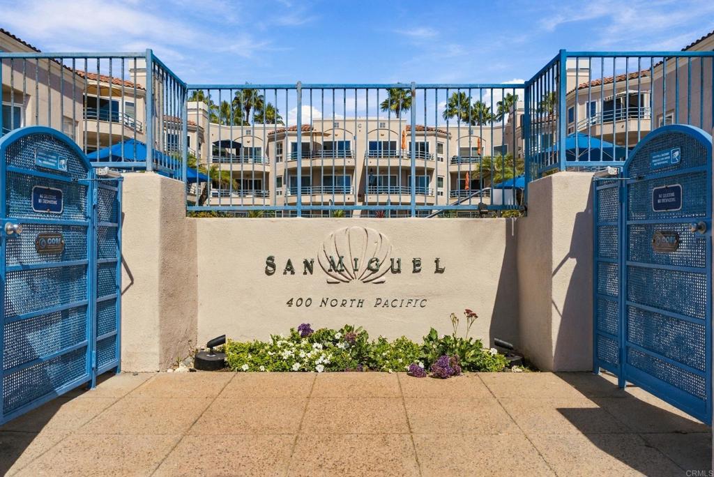 San Miguel condominium entrance with blue gates and a sign for 400 North Pacific.
