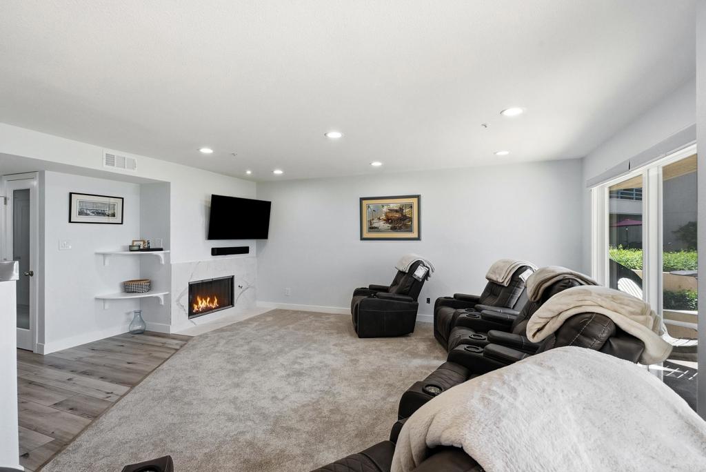 Living room with leather recliners, a fireplace, and sliding glass doors to a patio.