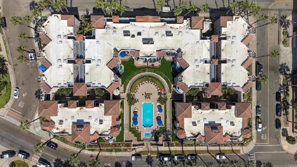 Aerial view of a residential complex with a central courtyard and swimming pool.