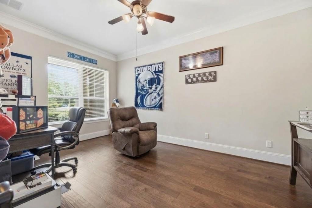 Home office with a brown recliner, desk, and Dallas Cowboys wall decor.