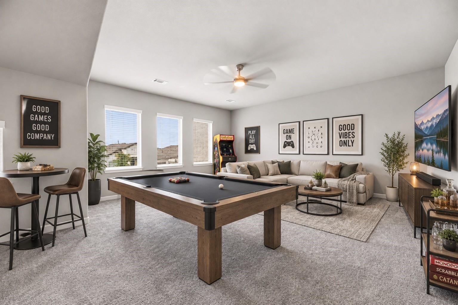 Furnished game room with a pool table, arcade cabinet, and sectional sofa.