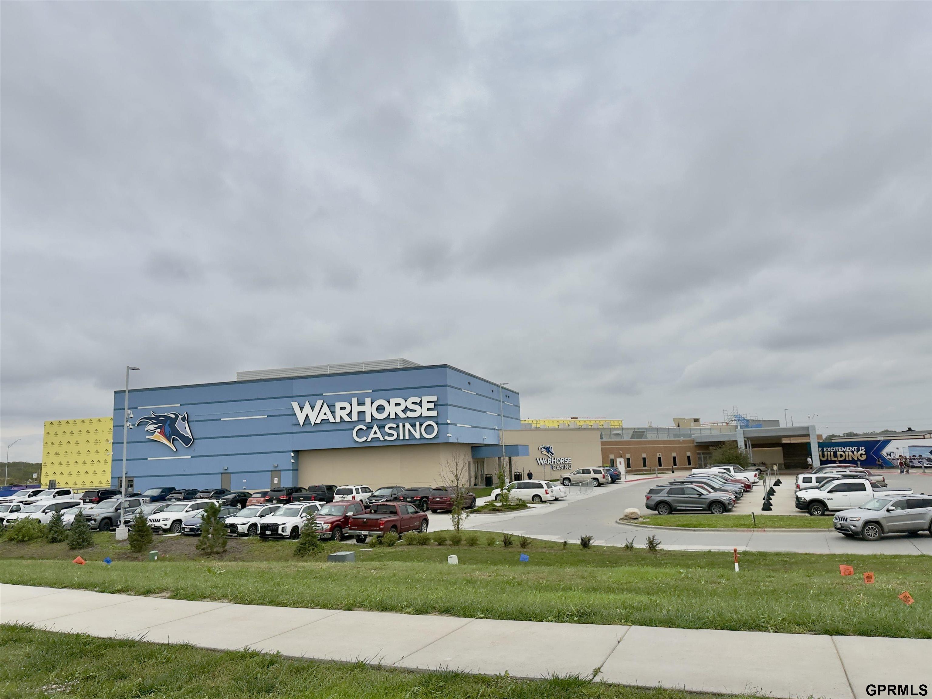 WarHorse Casino exterior with blue facade and a busy parking lot.