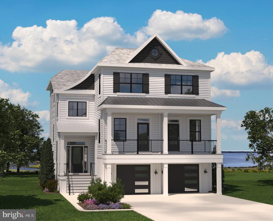 White coastal-style house with a covered balcony, double garage, and water view.