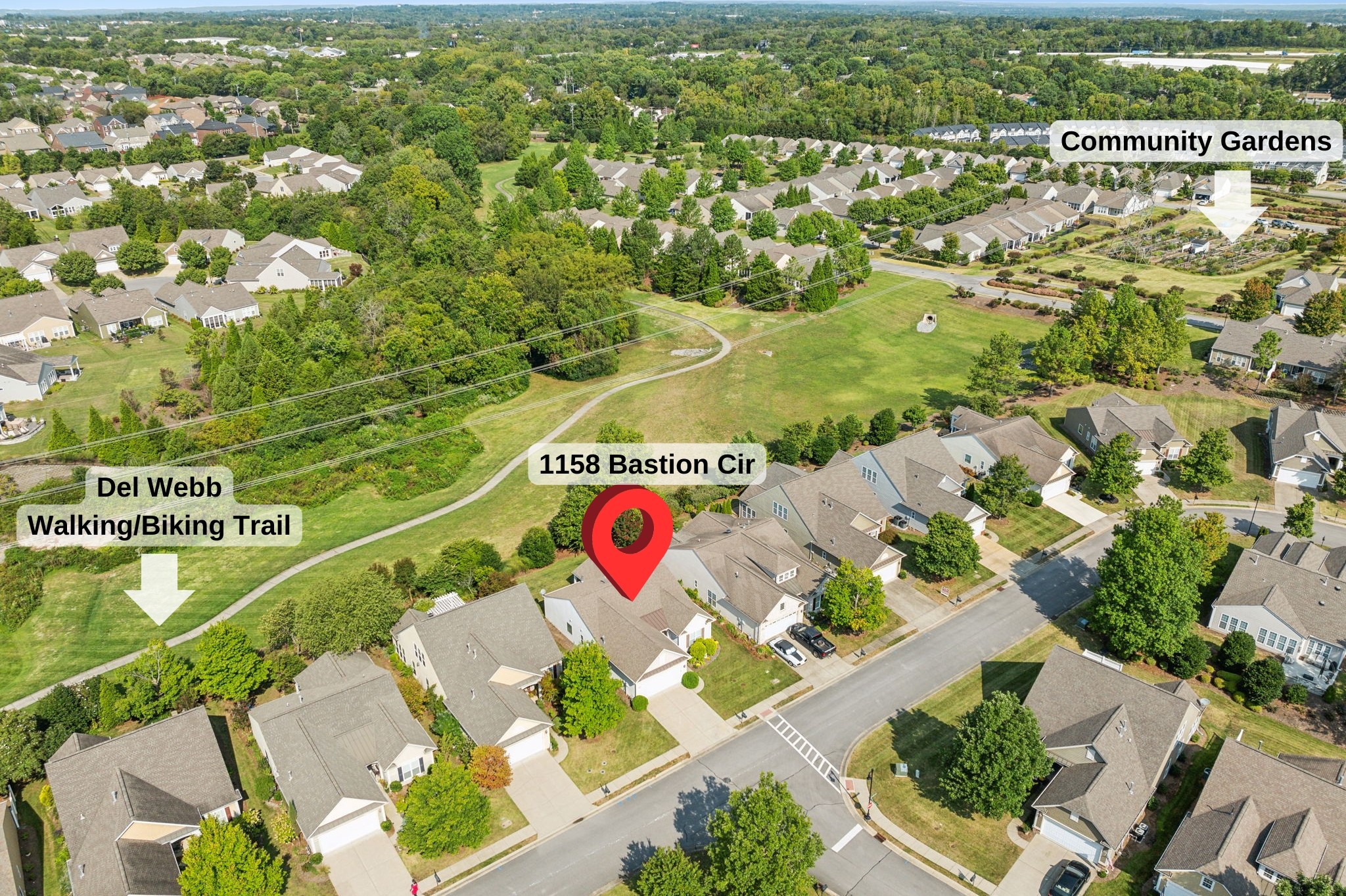 Aerial view of 1158 Bastion Cir beside a trail and community gardens.