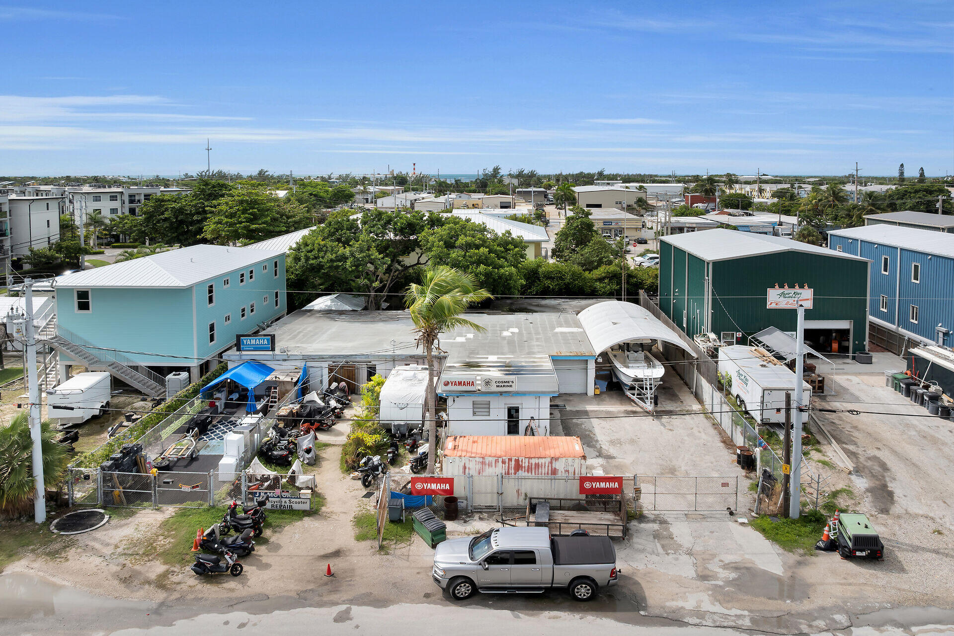 Aerial view of a marine business with boat storage canopies, boats, and Yamaha signs.