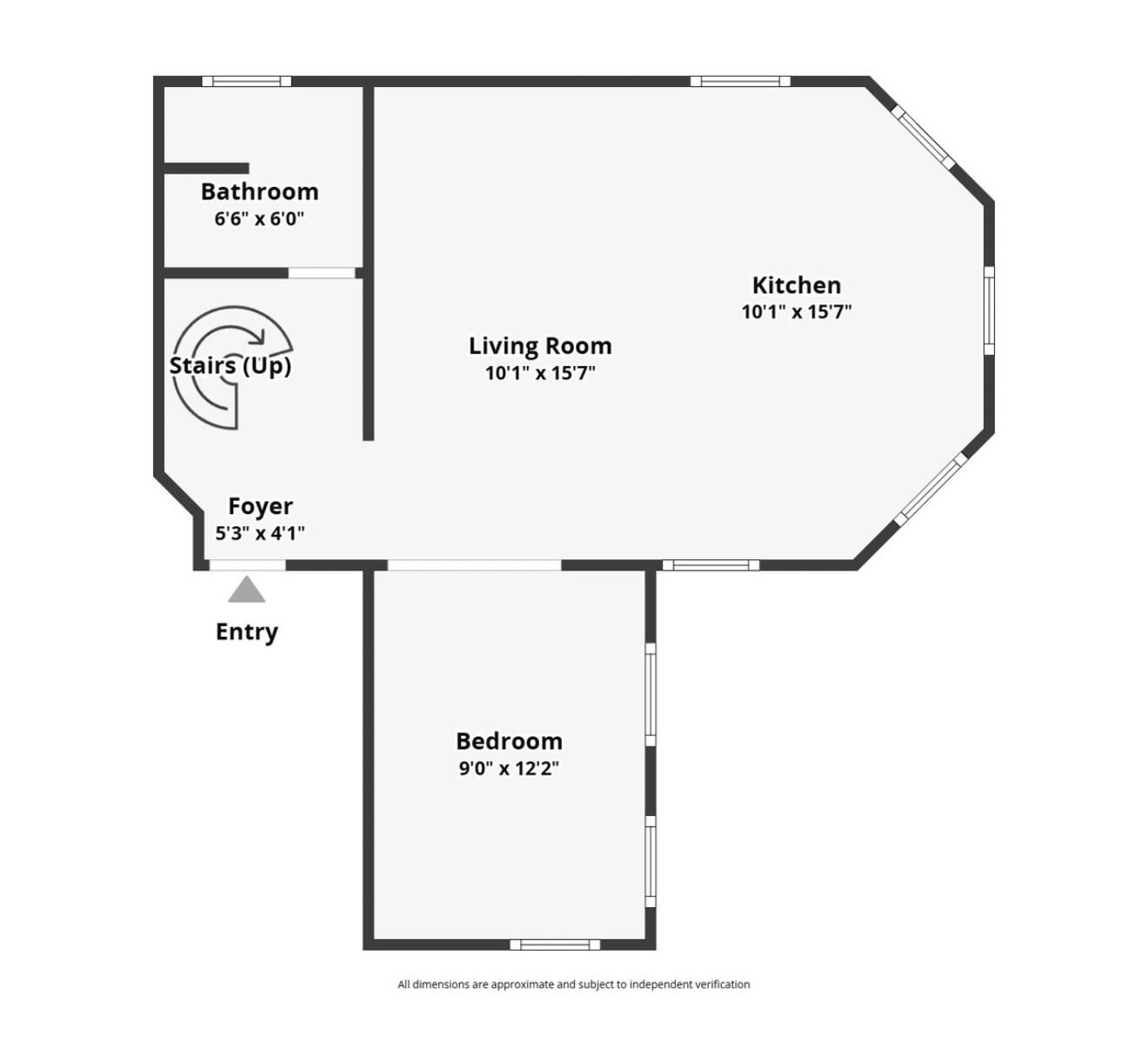 Floor plan showing one bedroom, bathroom, foyer, stairs, and open living room and kitchen.