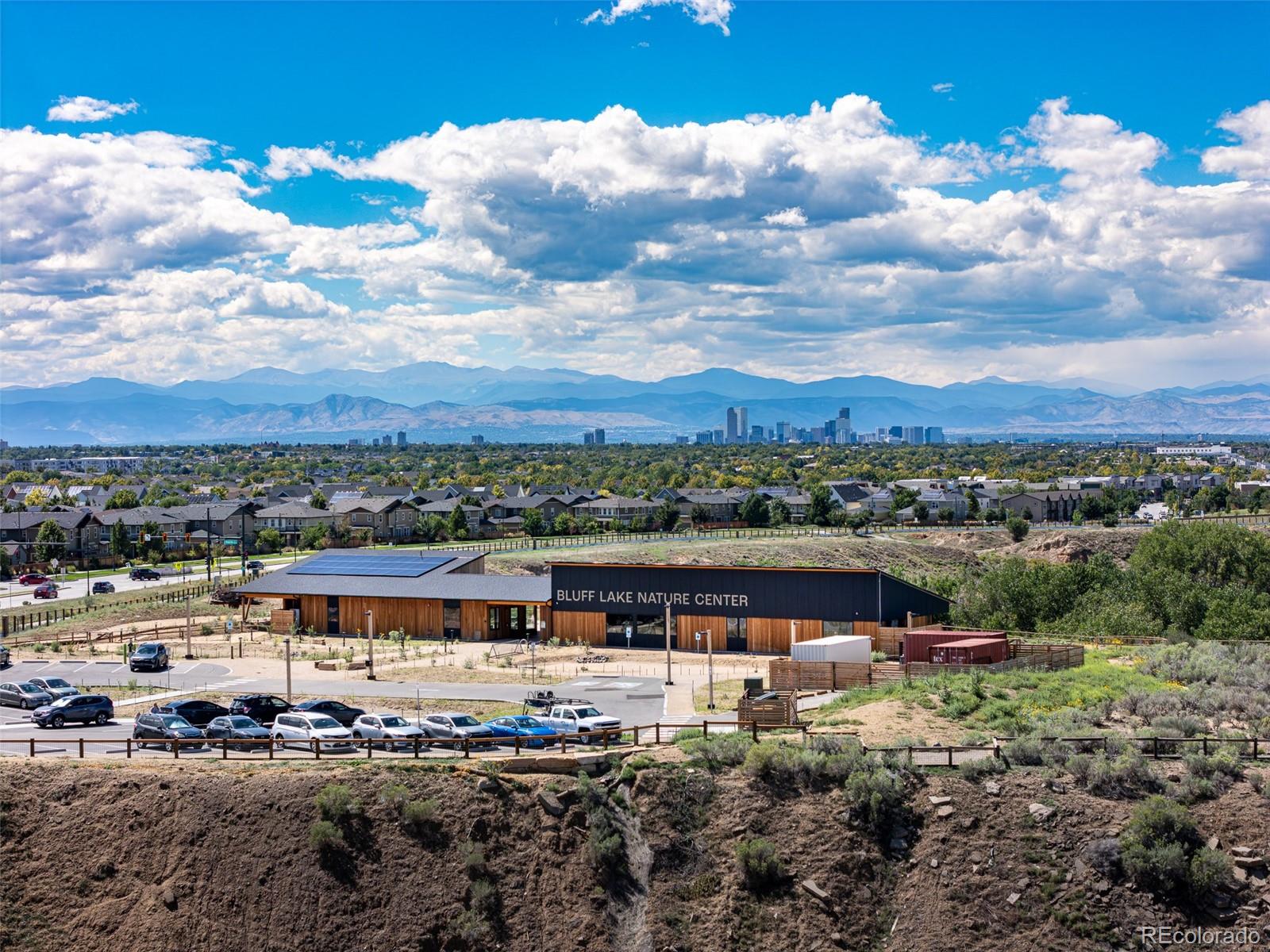 Panoramic view of Bluff Lake Nature Center, the Denver skyline, and Rocky Mountains.