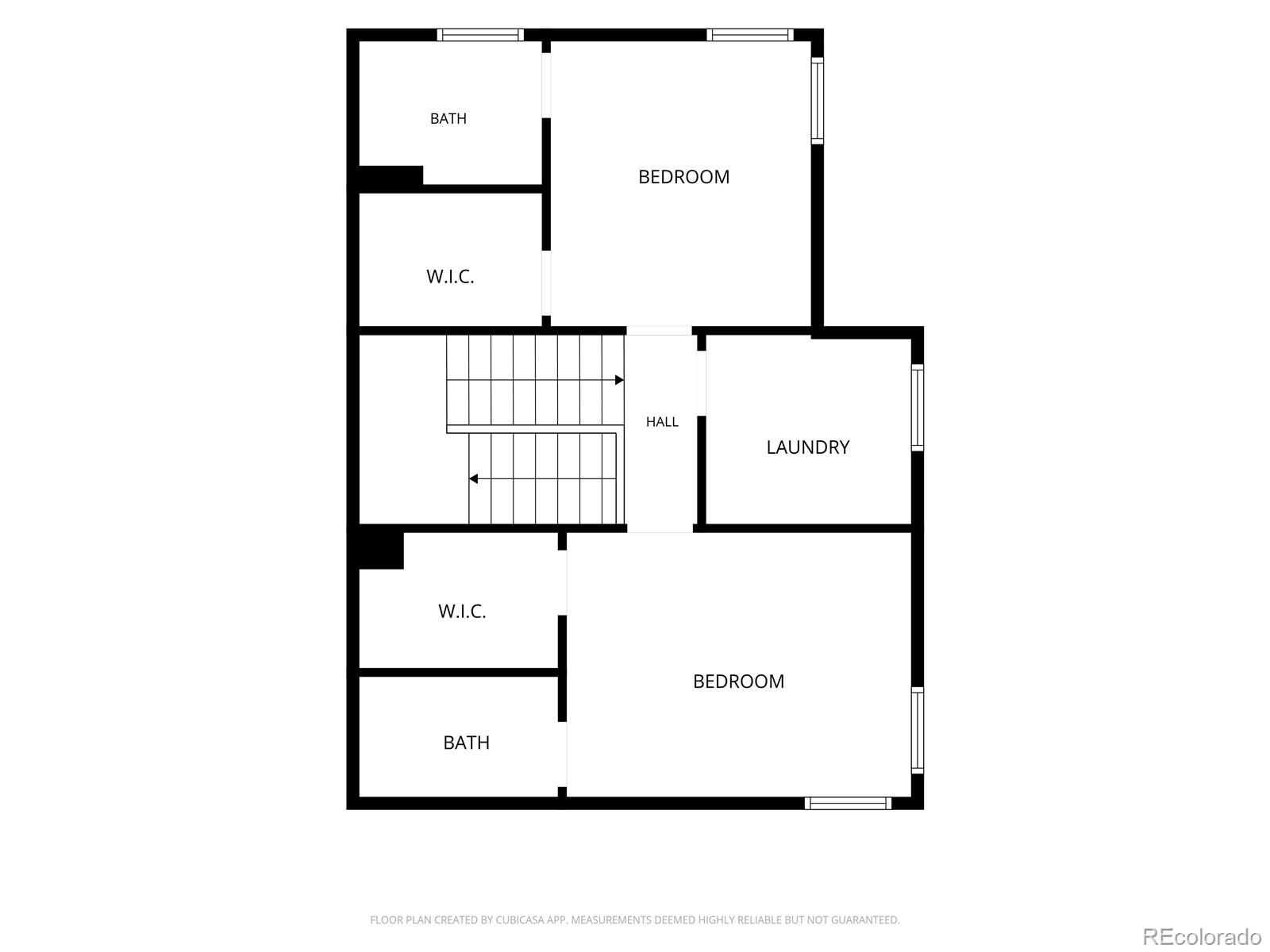 Floor plan with two bedrooms, two bathrooms, two walk-in closets, laundry room, and central staircase.