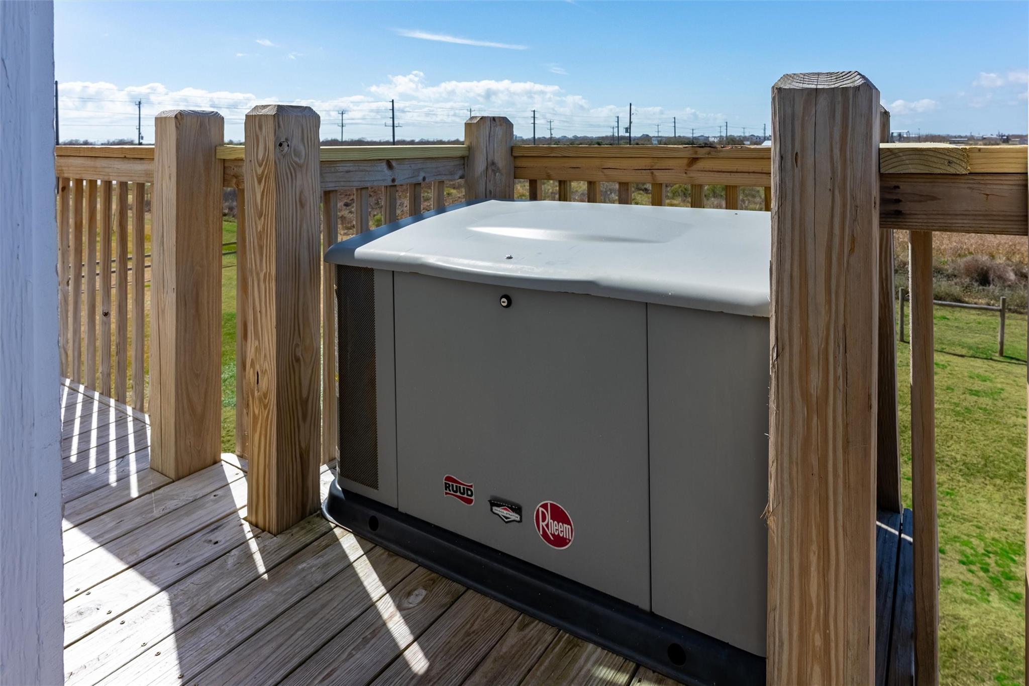 Outdoor HVAC unit on a wooden deck, surrounded by a timber railing.