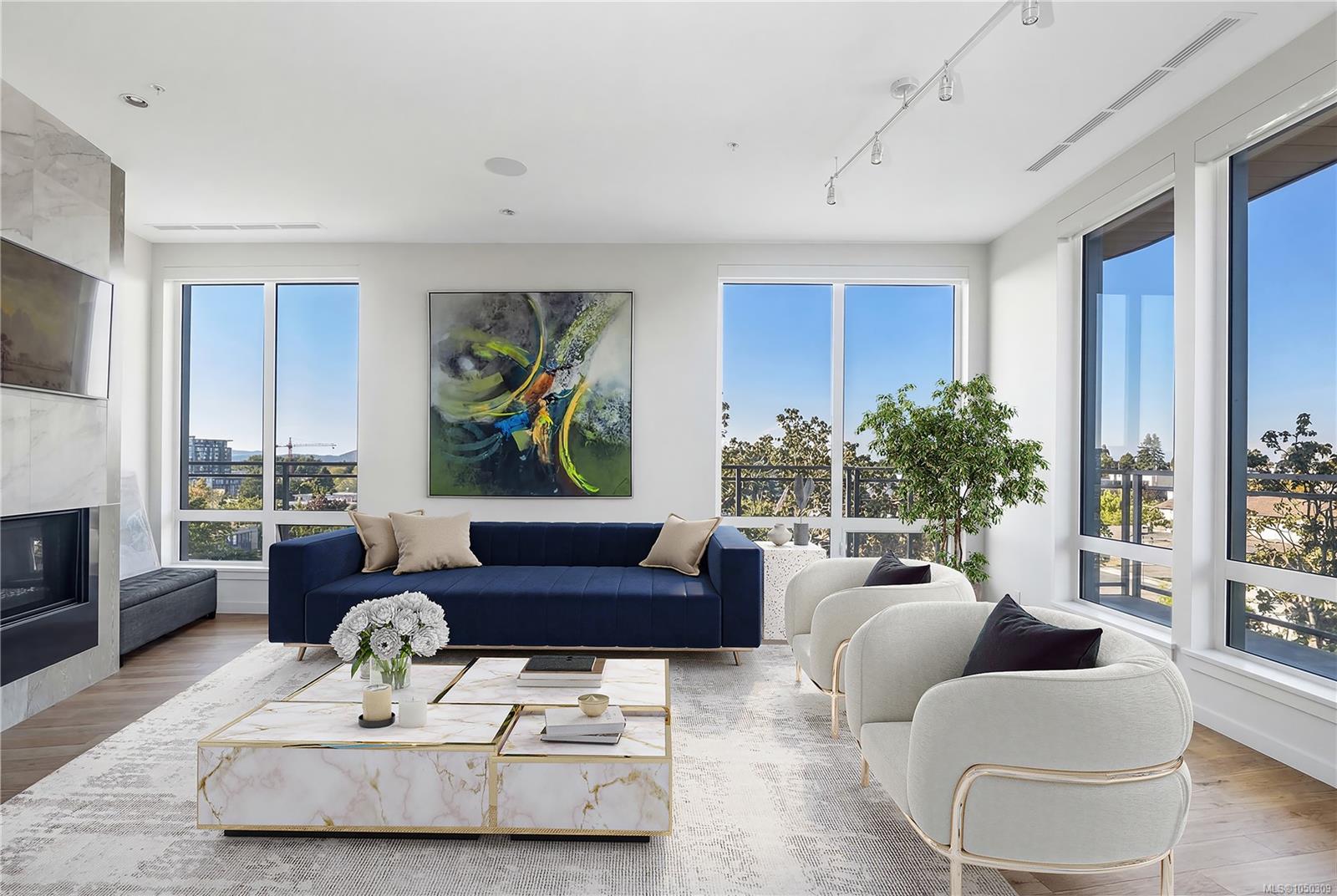 Bright living room with a navy sofa, cream chairs, marble coffee tables, and expansive windows.