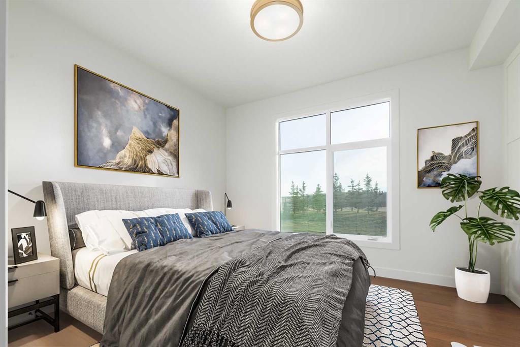 Bedroom with a gray upholstered bed, blue pillows, and a large window overlooking trees.