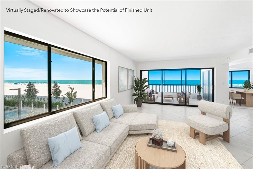Virtually staged living room with pale seating and large windows overlooking the beach and ocean.