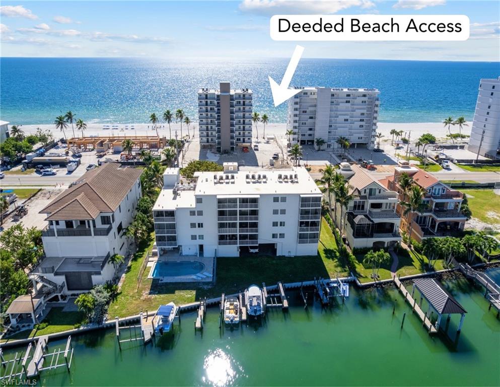 Aerial view of Bonita Beach waterfront homes, docks, and beachfront condominiums with deeded beach access.