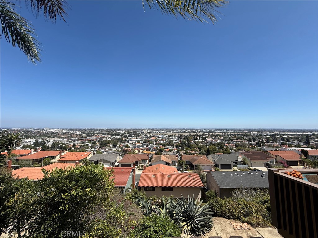 Panoramic view over Torrance rooftops and neighborhood from a hillside property.