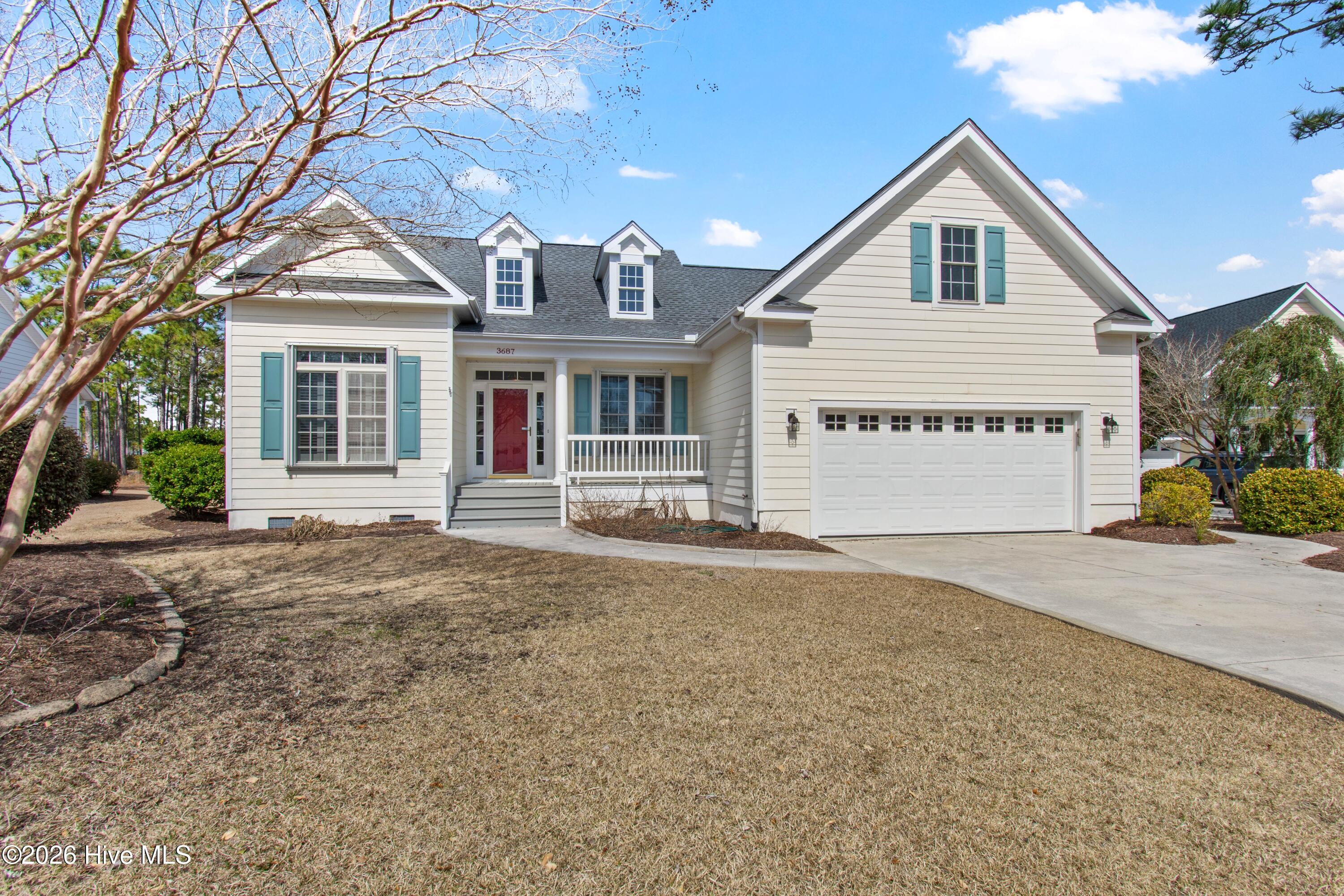 House exterior with teal shutters, a red front door, and an attached two-car garage.