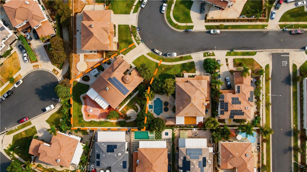 Aerial view of 13482 Redwood, with its parcel outlined, backyard pool, and rooftop solar panels.