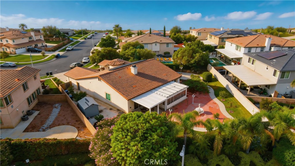 Aerial view of 13482 Redwood, showing its terracotta tile roof, covered patio, and landscaped yard.