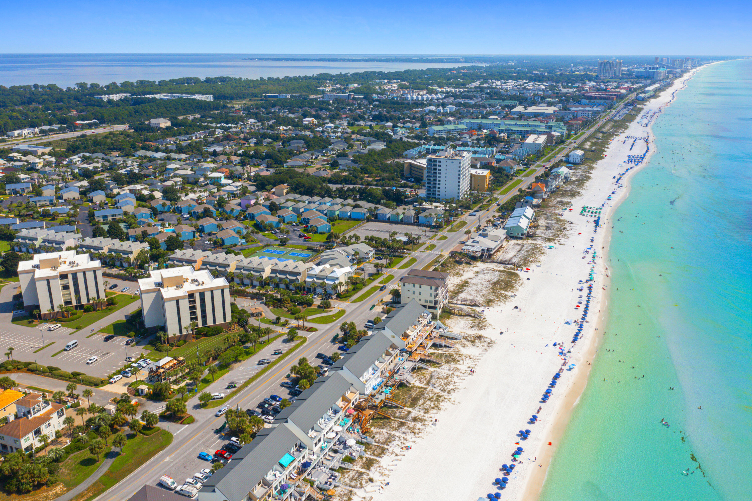 Aerial view of Destin’s white-sand beach, turquoise water, beachfront condos, and Scenic Highway 98.