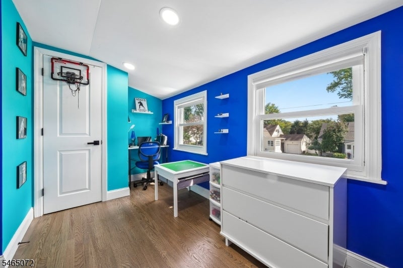 Playroom with a door-mounted basketball hoop, game table, and large windows.
