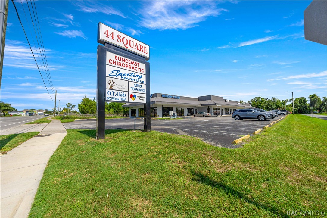 Commercial plaza with a tall 44 Square tenant sign and a parking lot.