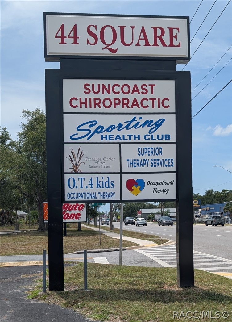Freestanding 44 Square directory sign beside a roadway, listing Suncoast Chiropractic and other businesses.